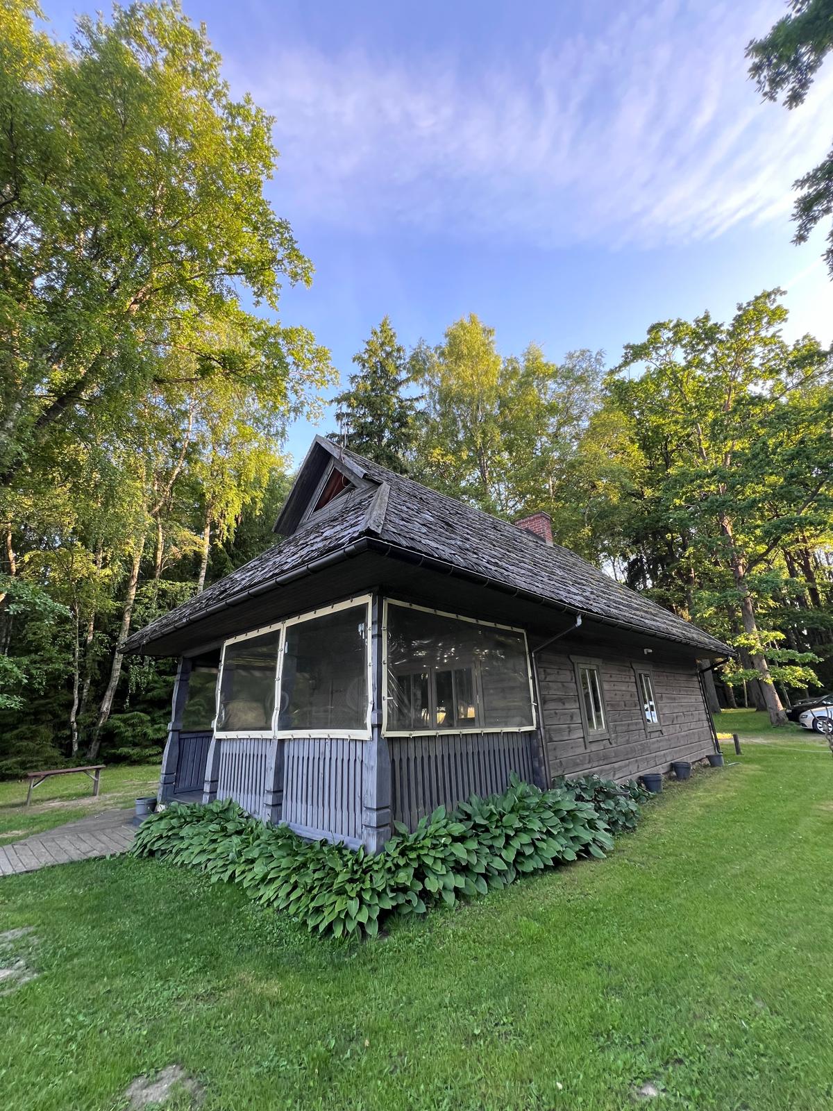 Architectural lakeside pavilion with a deck over the water.